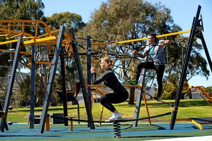 Outdoor fitness equipment being used at an apartment complex